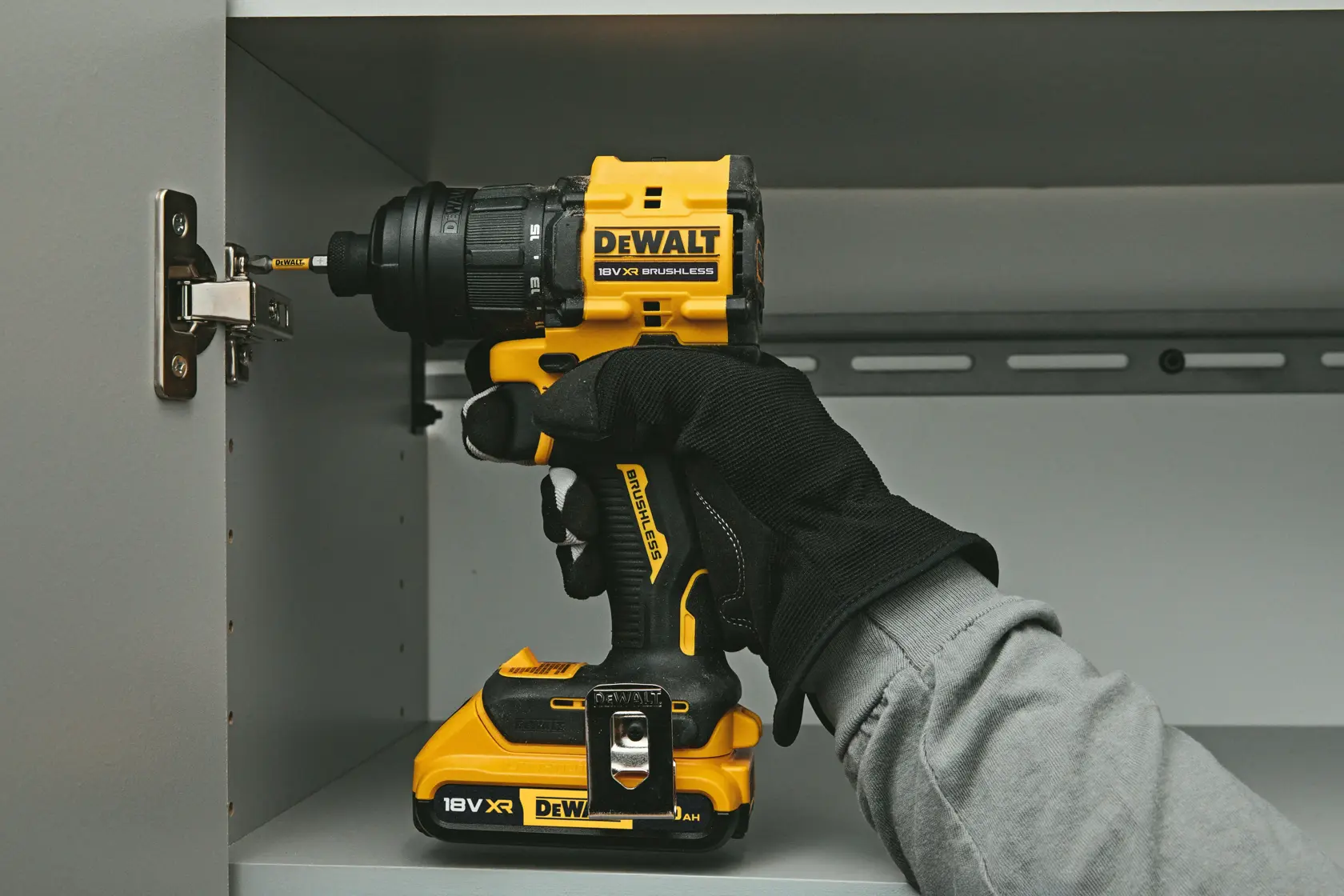 DEWALT drill with interchangeable heads being used under a vehicle, showing tool versatility.