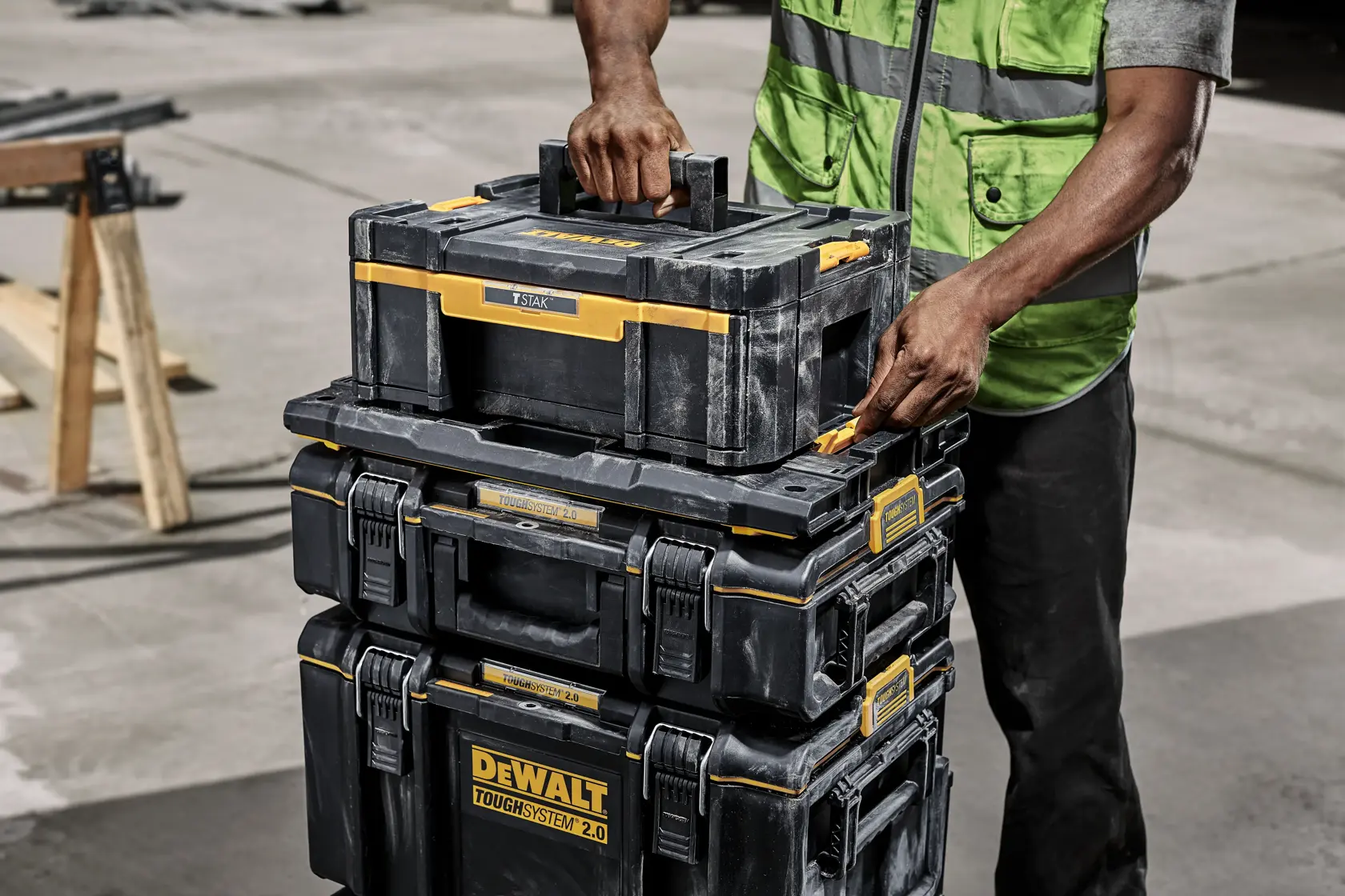 DEWALT ToughSystem 2.0 black tool storage box with yellow latches and handle, shown from the top view.