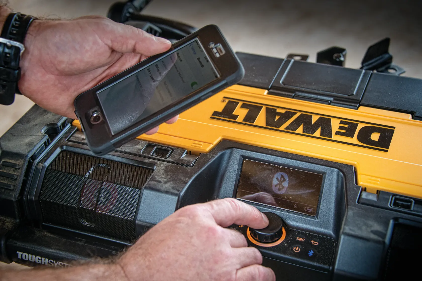 DEWALT ToughSystem 2.0 promotional graphic with the slogan 'Storage Built to Handle It' in large, bold yellow lettering on a dark, textured background.